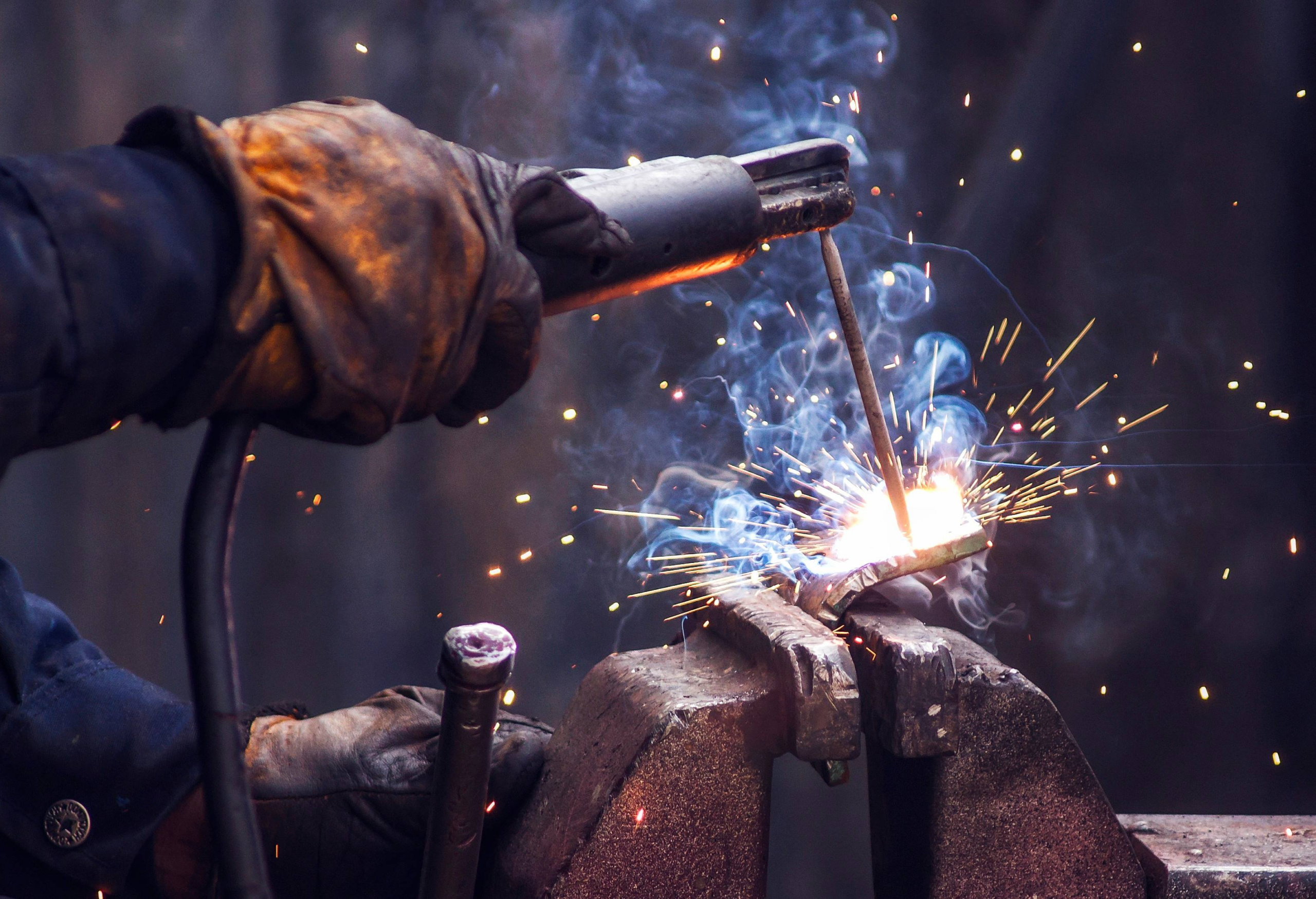 industry worker welding iron