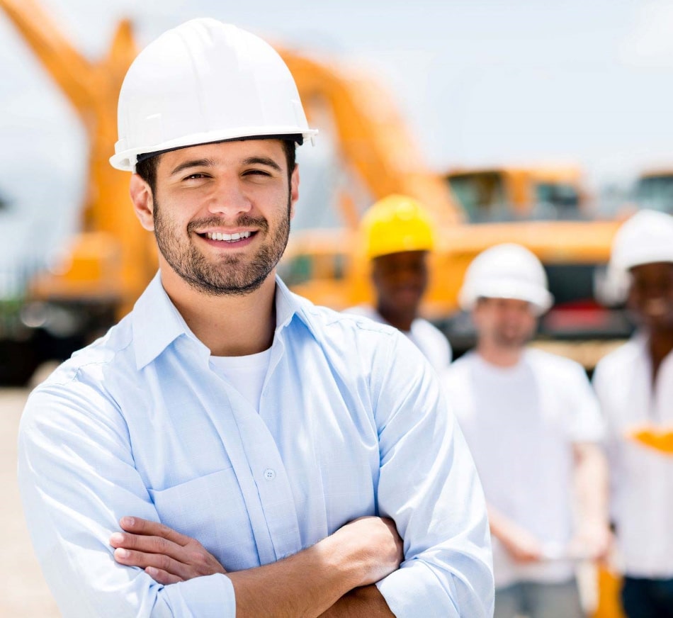 Construction Man Wearing a Hard Hat Smiling at You With Their Arms Crossed