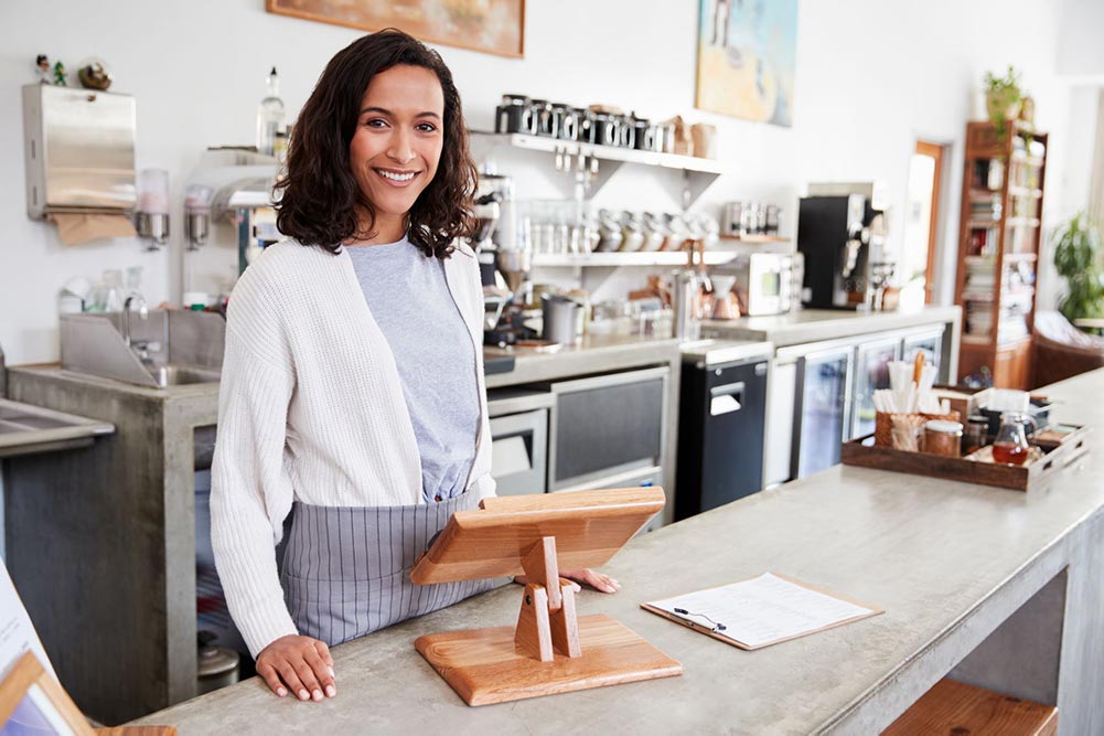 woman standing serving bar