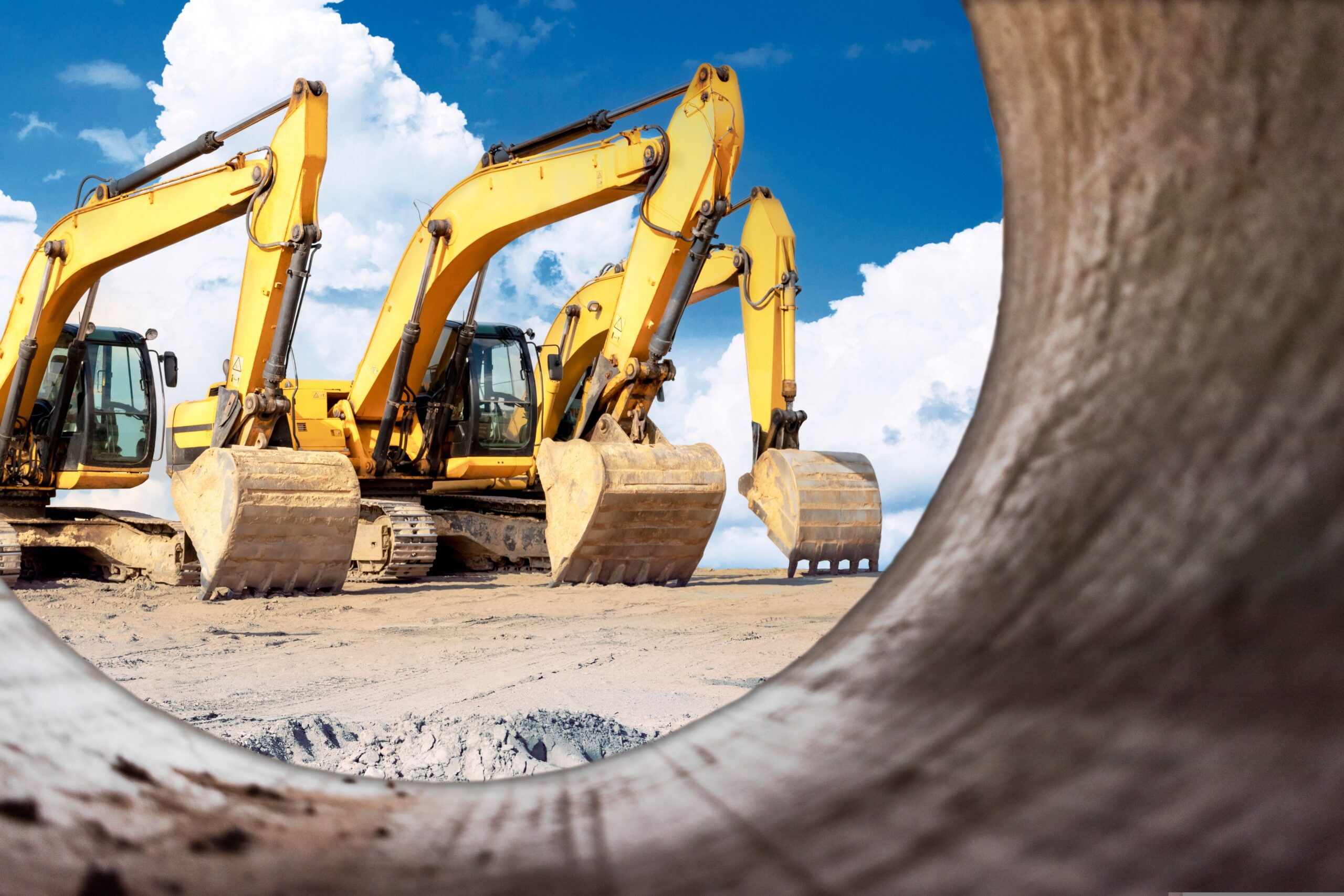 Powerful,Excavators,At,A,Construction,Site,Viewed,From,A,Large