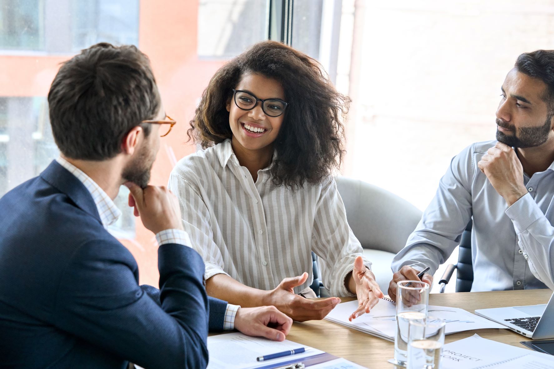 colleagues around table smiling medium