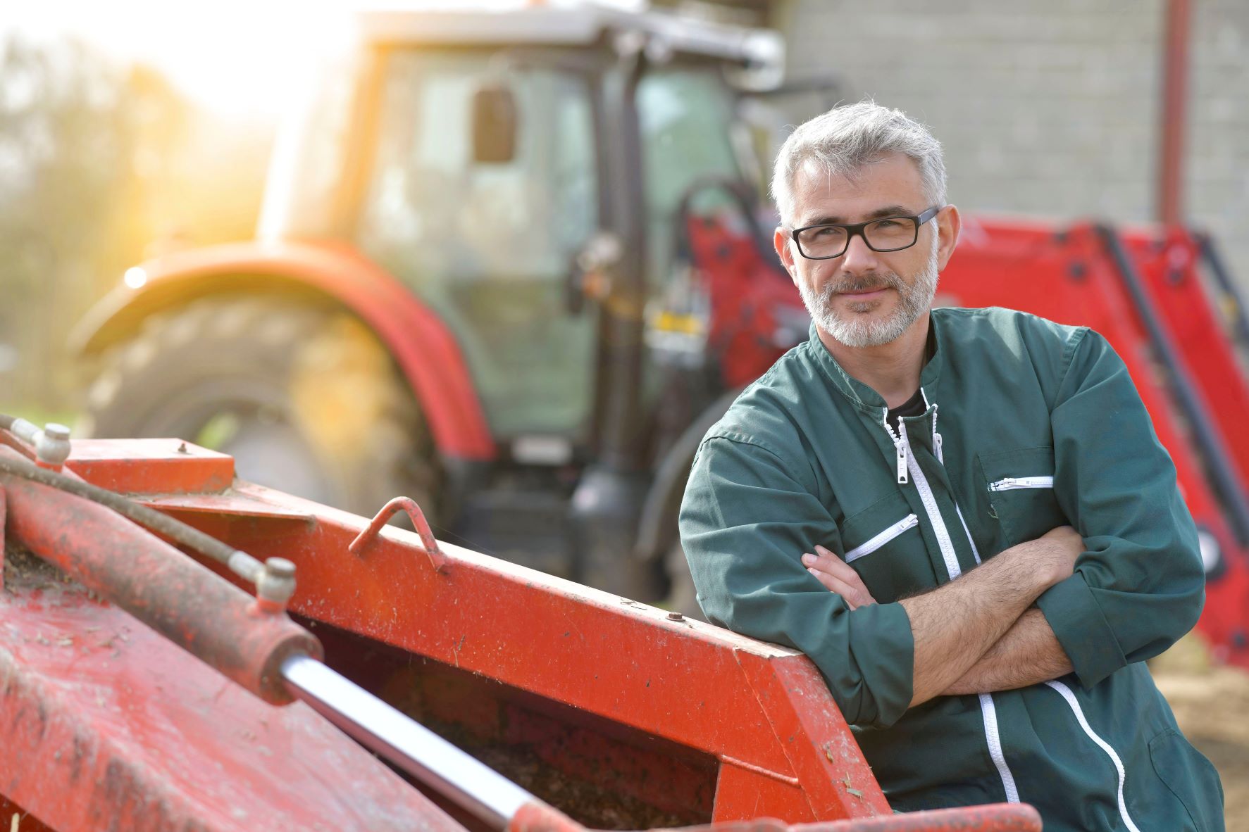 farmer stood red tractor medium