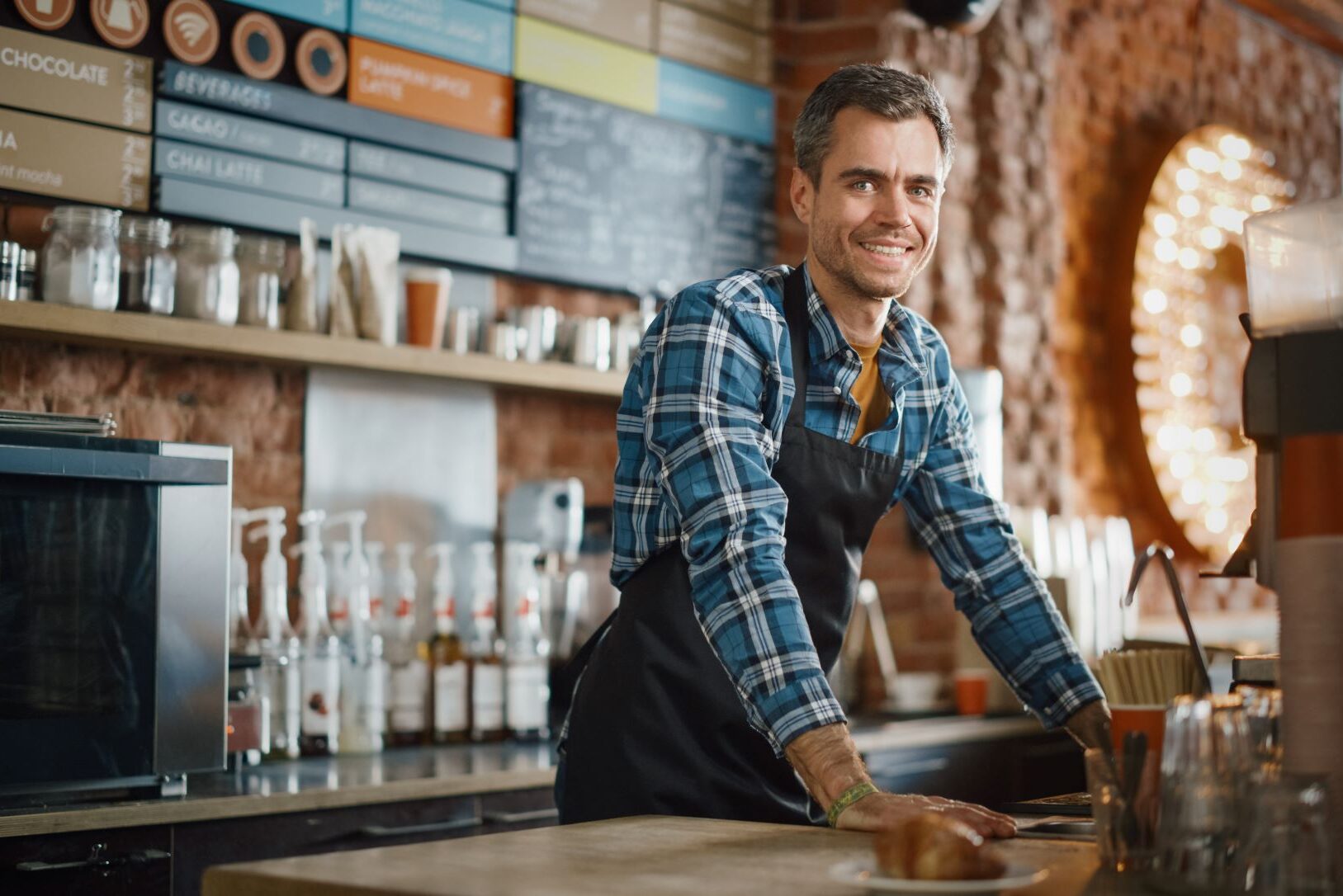 male barista coffee shop smiling medium e1696005125531