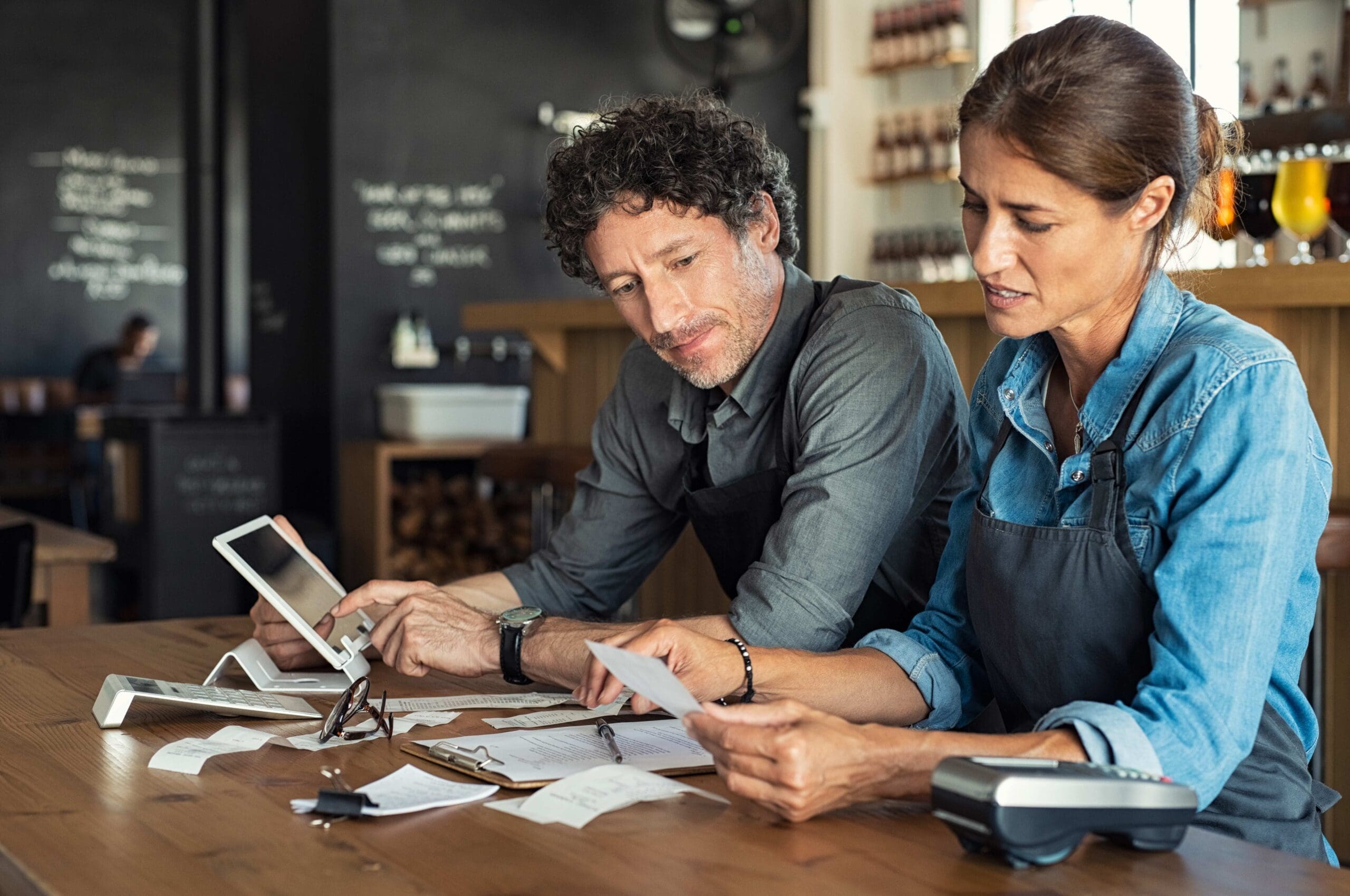 male female workers looking at invoices scaled