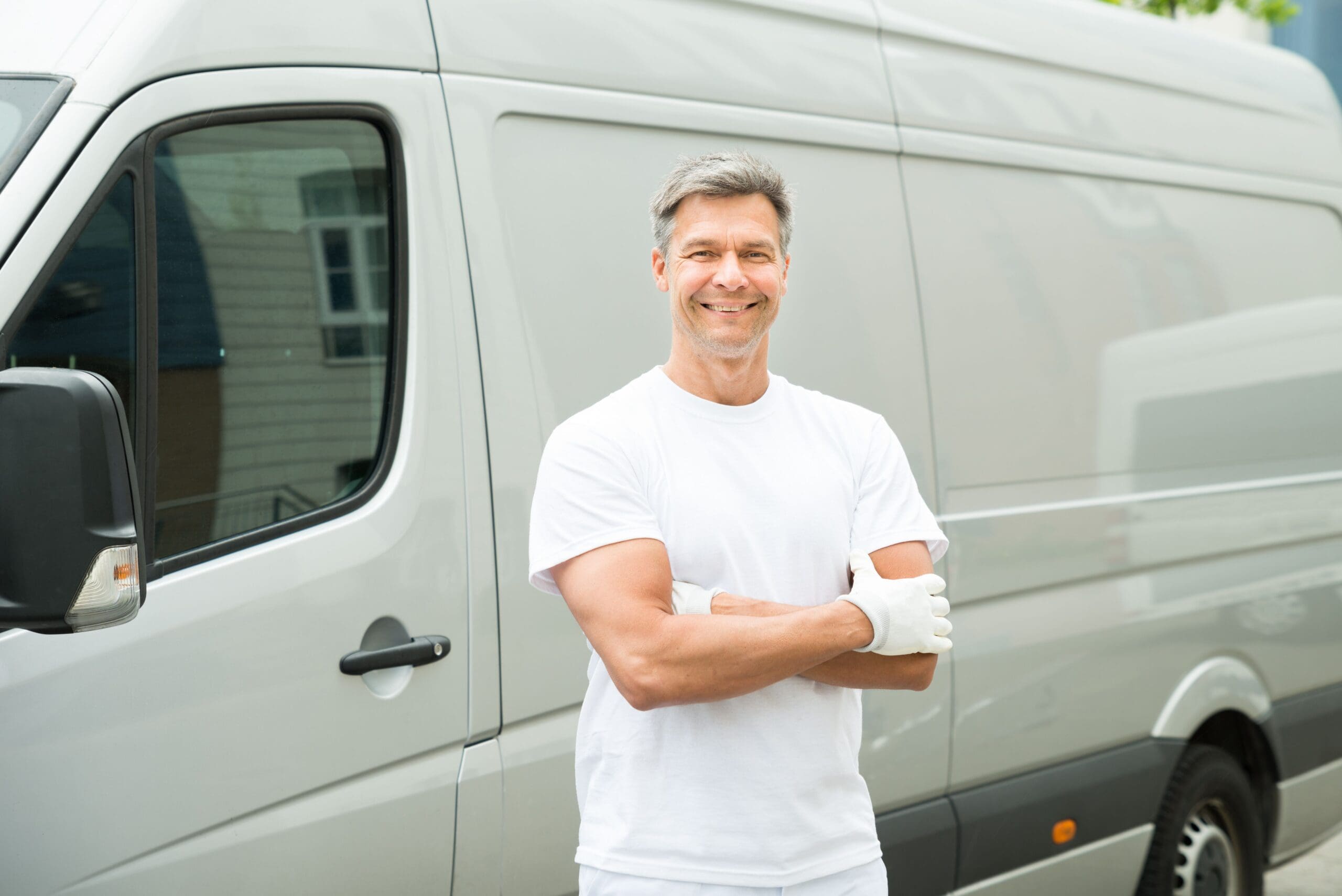 Man standing next to commercial van vehicle