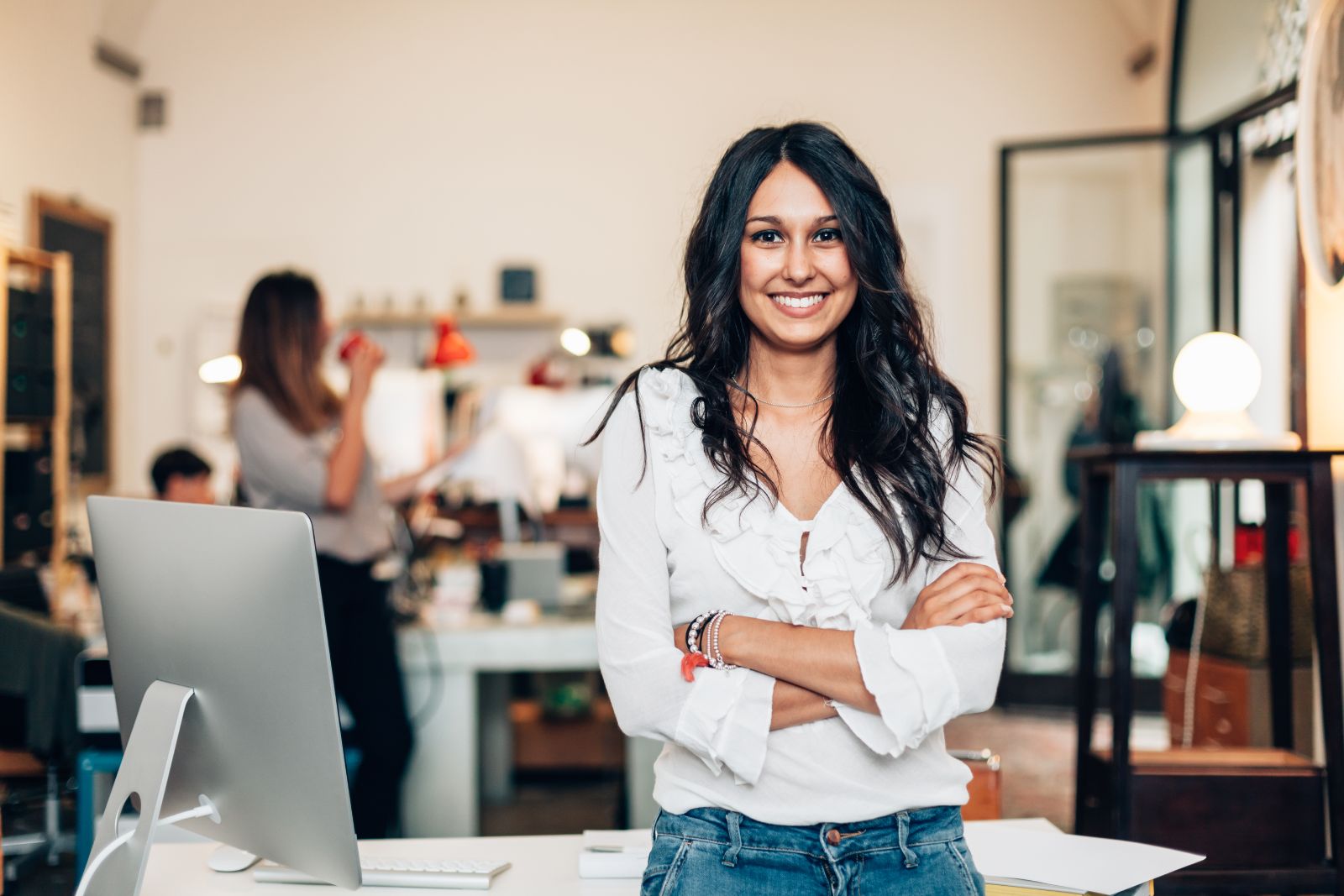 woman leaningdesk whiteshirt