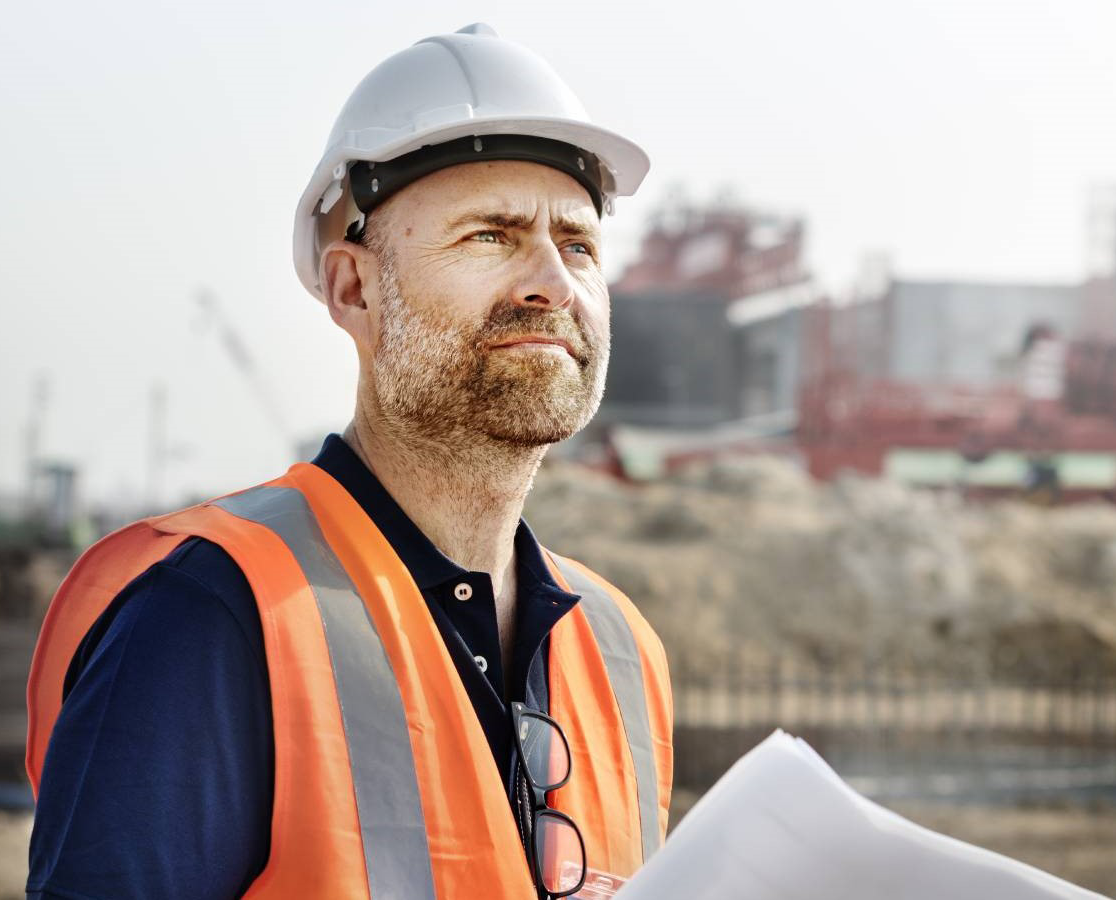 construction worker holding plans