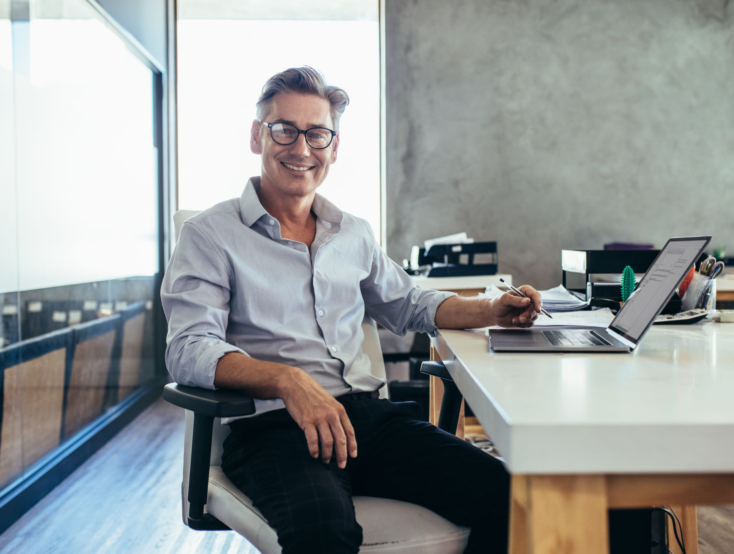 male businessman smiling desk medium