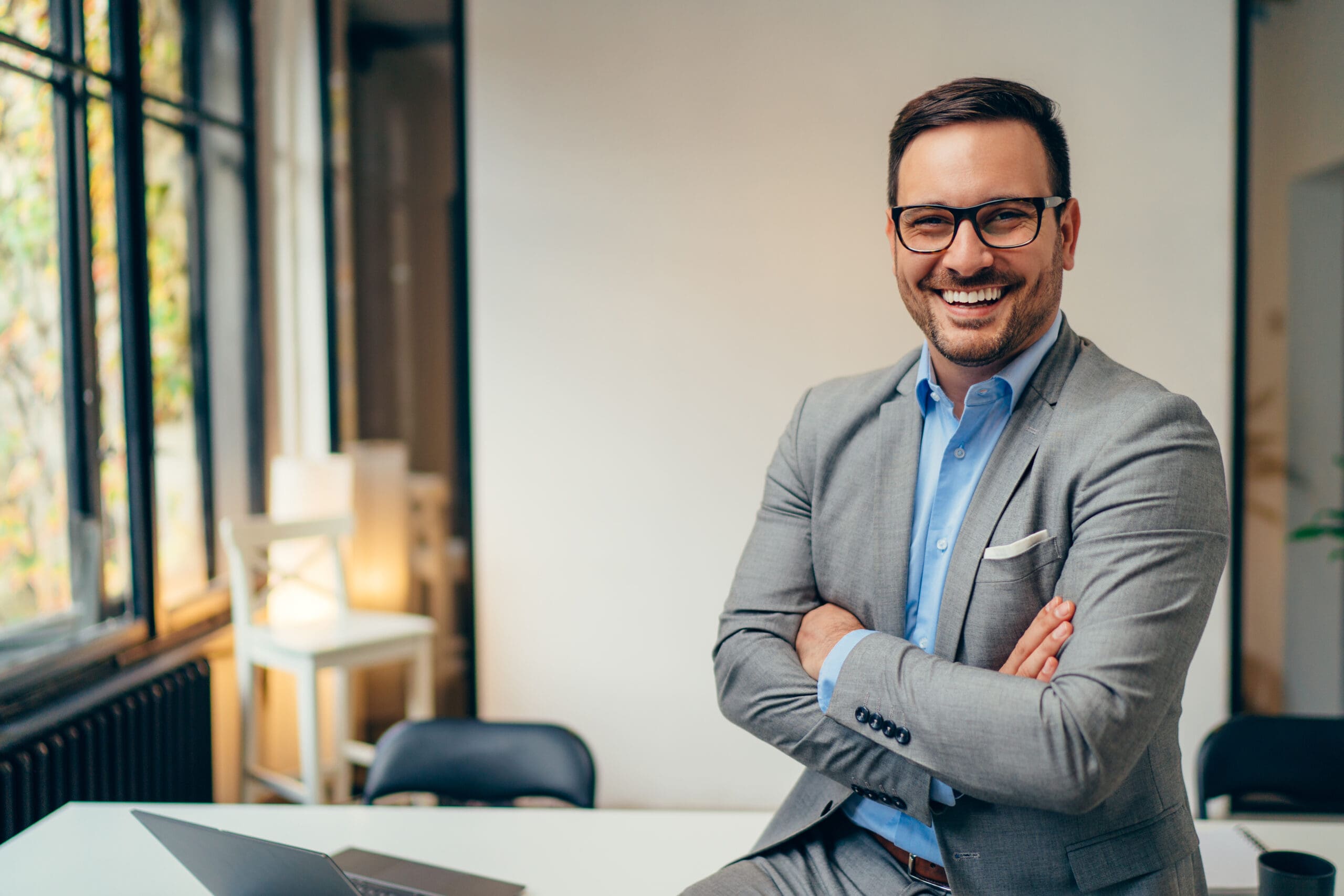 businessman suit arms folded scaled