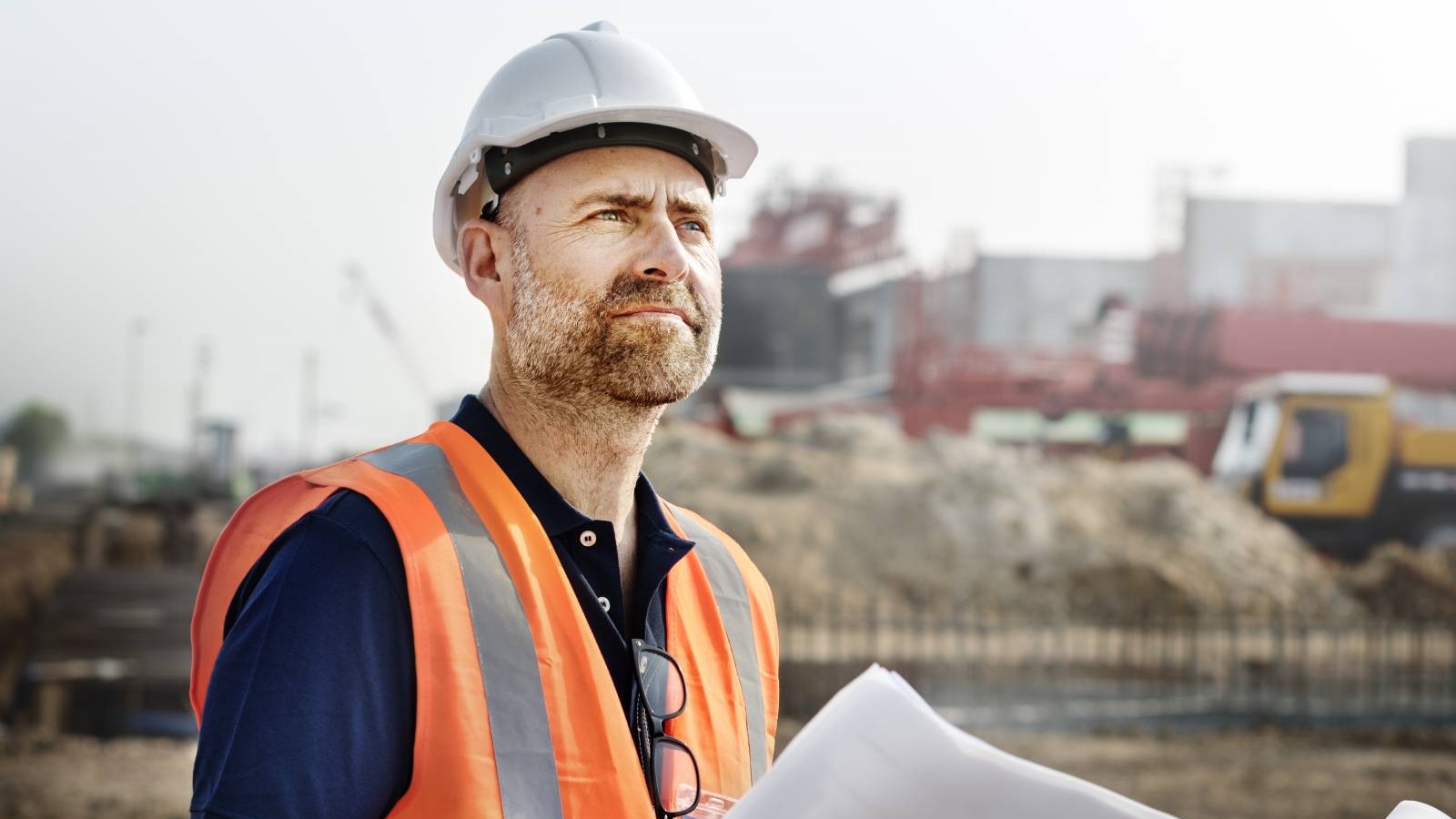 construction worker holding plans