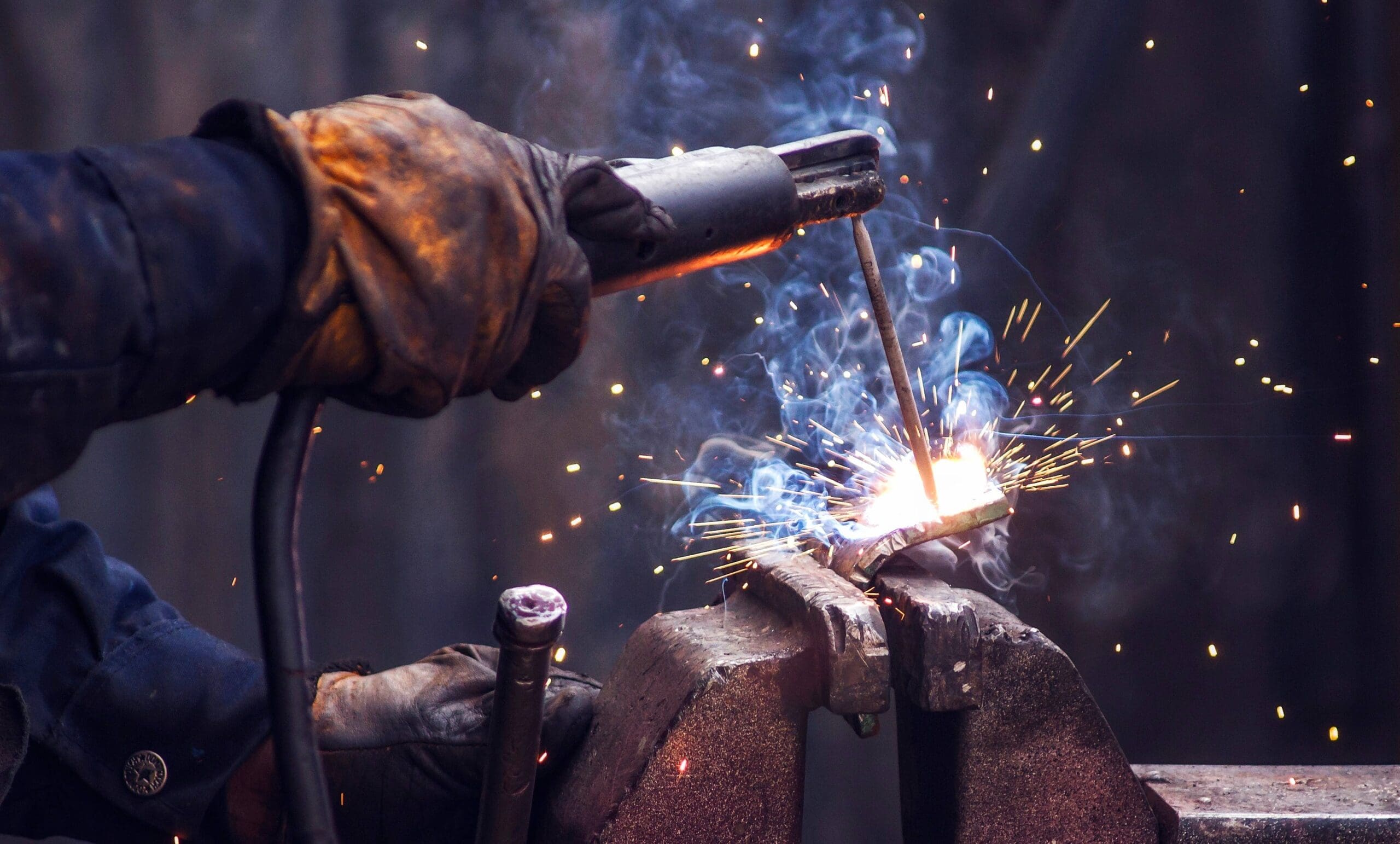 industry worker welding iron scaled