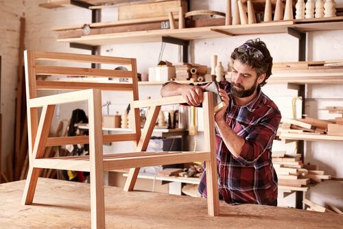 Worker making furniture out of wood