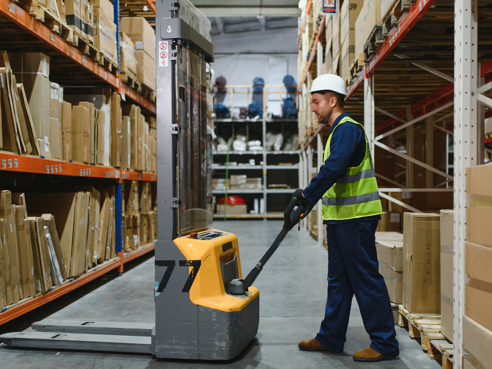Man in warehouse using material handling equipment